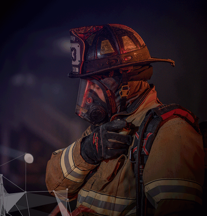 Photo of fireman with radio. MCP helps mission-critical agencies with LMR system upgrades.