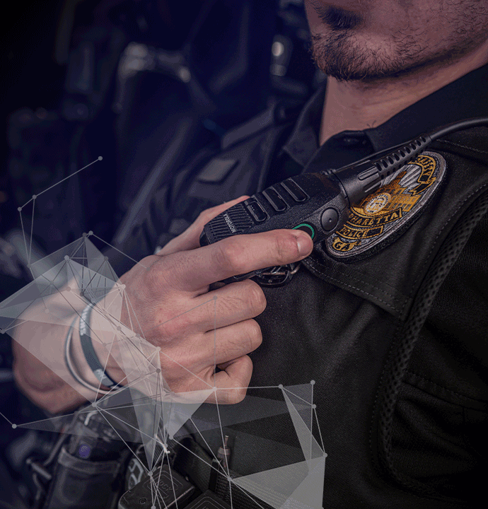 Photo of policeman with radio. MCP excels in modernizing legacy land mobile radio systems for mission-critical agencies.